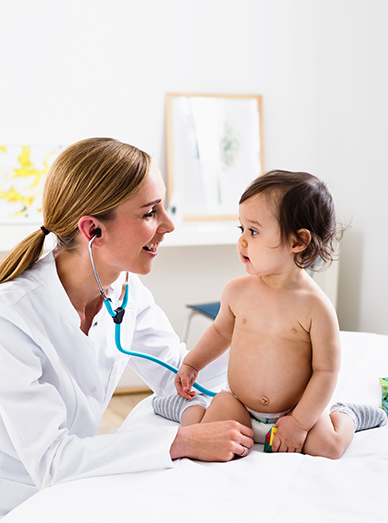 Clinician using a pediatric stethoscope to assess a seated baby during a check-up at Mittagong Doctors.