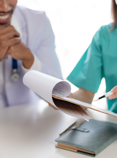 Healthcare team reviewing paperwork and discussing results at Mittagong Doctors.