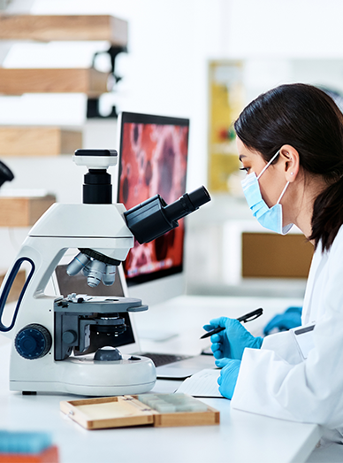 Laboratory technician using a microscope with prepared samples at Mittagong Doctors.