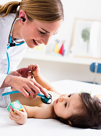 Female doctor listening to an infant’s chest with a stethoscope while the child plays at Mittagong Doctors.