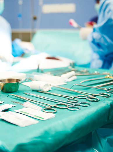 Sterile surgical instruments laid out on a draped tray in a procedure room at Mittagong Doctors.